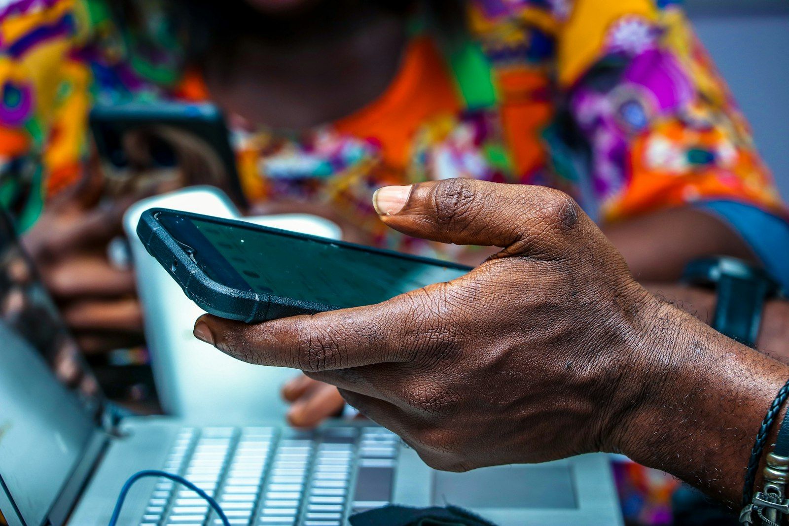 A person using a smartphone outdoors on a city street.